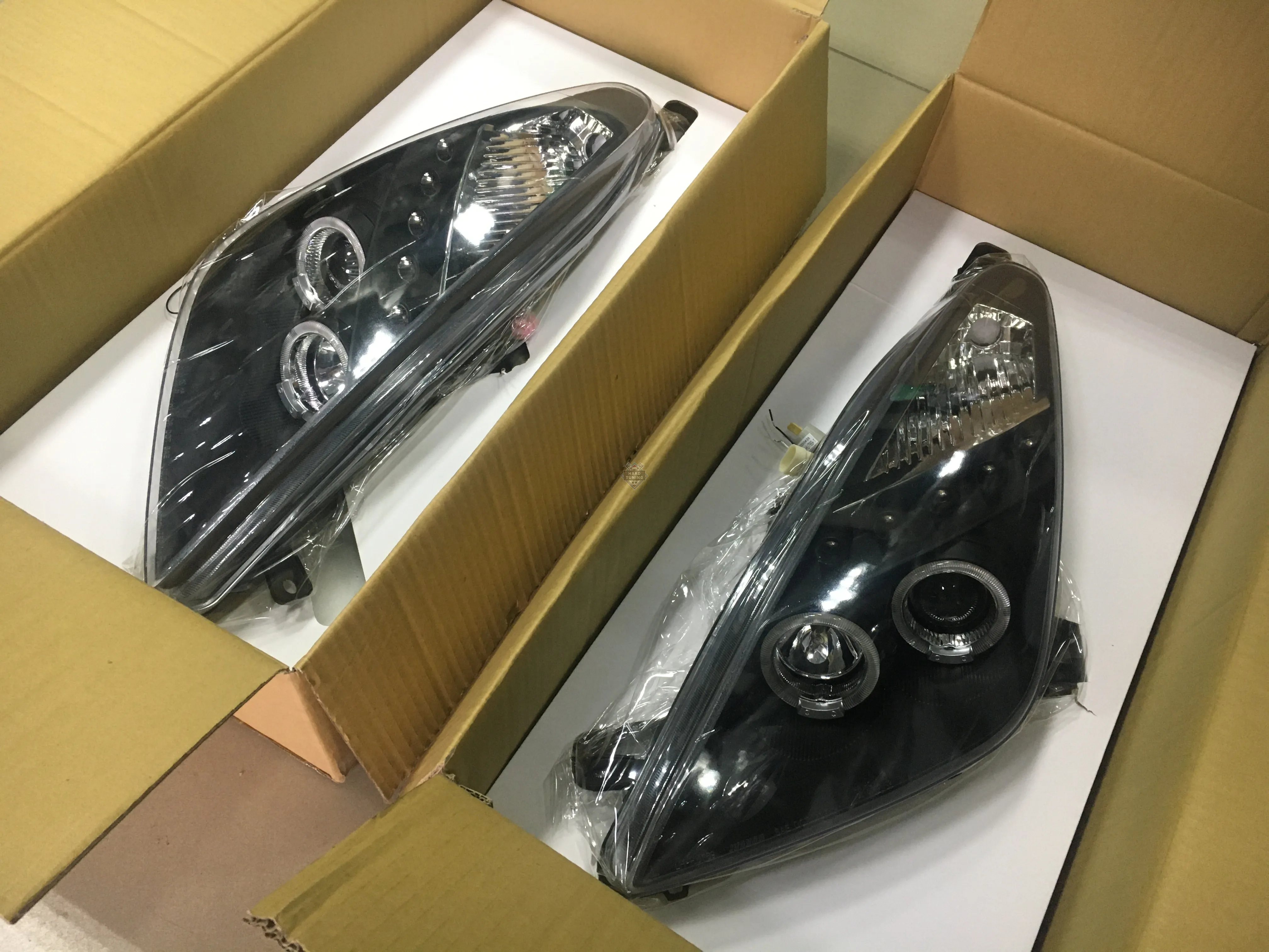 Передние фары Toyota Celica T230 (1999-2005) Angel Eyes черные