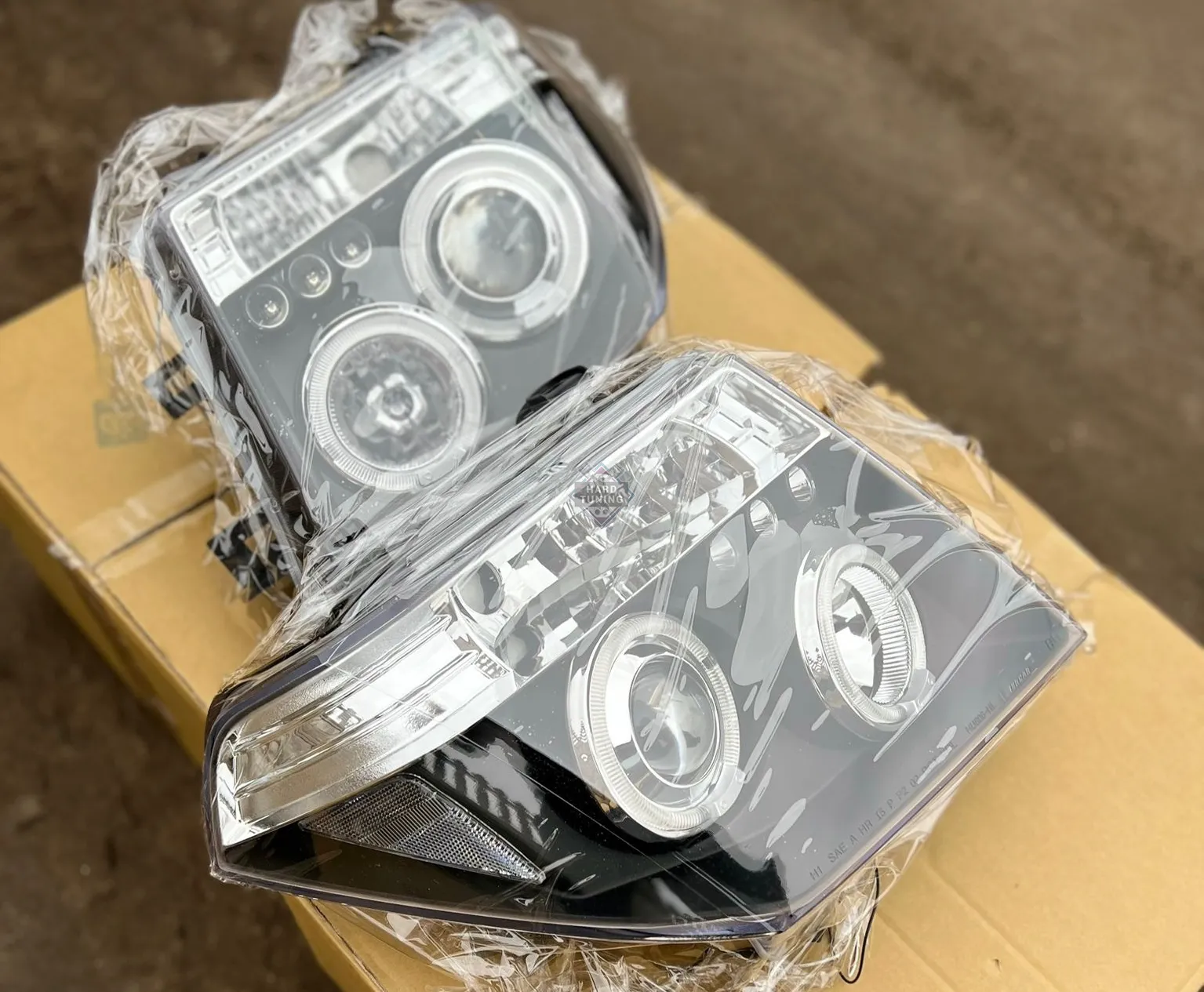 Передние фары Nissan Navara D40 / Pathfinder (2005-2010) Angel Eyes черные